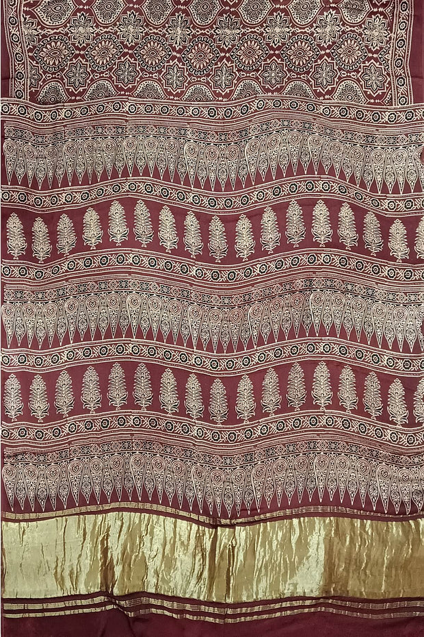 Modal silk saree in maroon with floral motifs  in hand block ajrakh print
