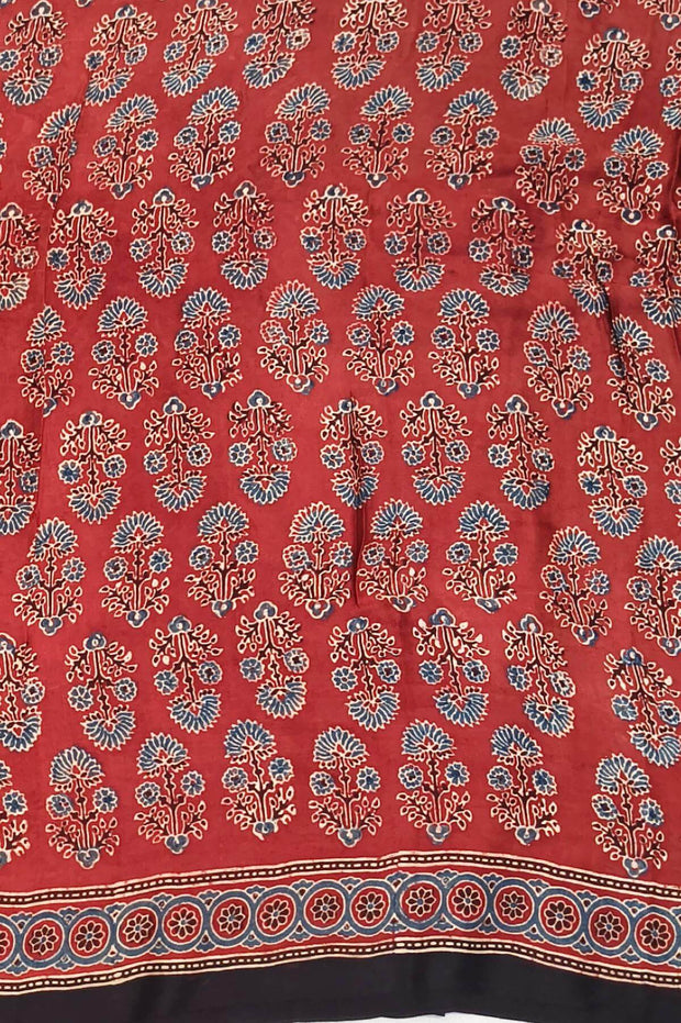 Modal silk saree in red with floral motifs  in hand block ajrakh print and a tissue pallu