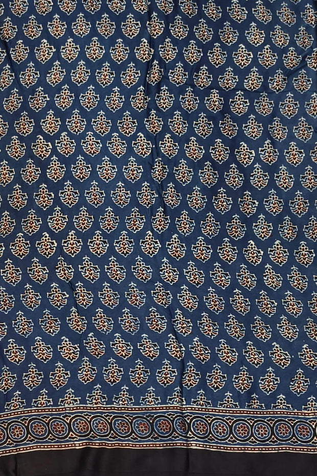 Modal silk saree in blue with floral motifs  in hand block ajrakh print and a tissue pallu