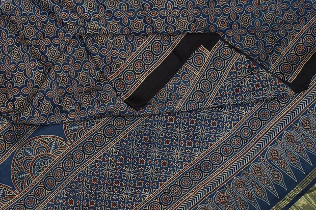 Modal silk saree in blue with floral motifs  in hand block ajrakh print and a tissue pallu
