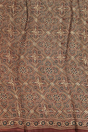 Modal silk saree in maroon with round motifs  in hand block ajrakh print and a tissue pallu