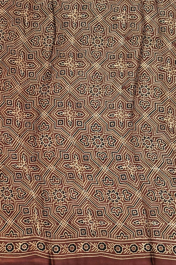 Modal silk saree in maroon with round motifs  in hand block ajrakh print and a tissue pallu