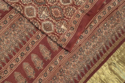 Modal silk saree in maroon with round motifs  in hand block ajrakh print and a tissue pallu