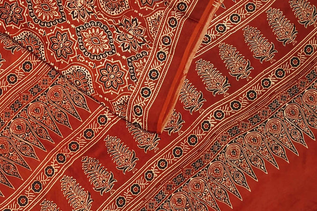 Modal silk saree  in red with  round motifs in hand block ajrakh print.