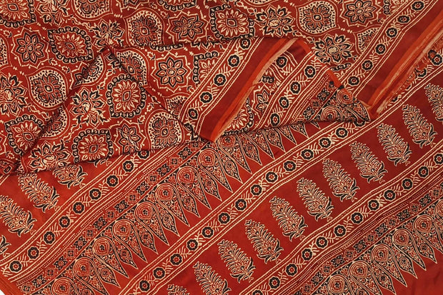 Modal silk saree  in red with  round motifs in hand block ajrakh print.