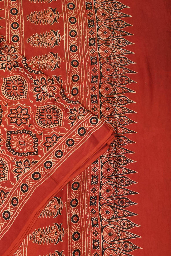 Modal silk saree in red in hand block ajrakh print in floral pattern
