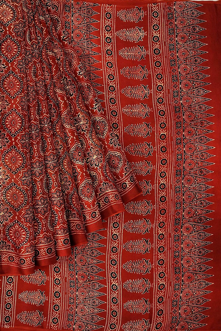 Modal silk saree in red in hand block ajrakh print in floral pattern