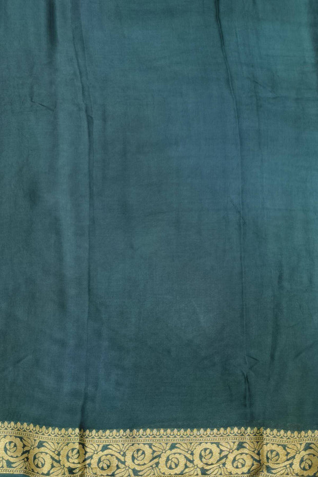 Modal silk saree in  shaded bottle green with zari pallu & borders.
