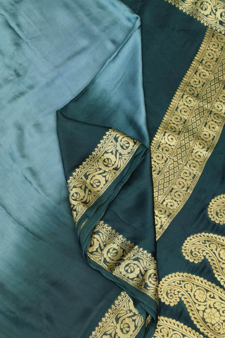 Modal silk saree in  shaded bottle green with zari pallu & borders.