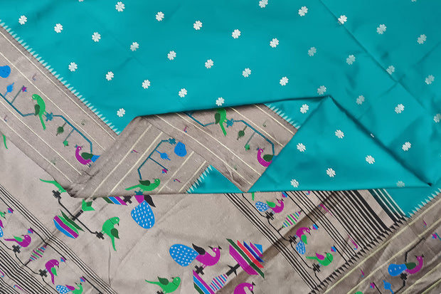 Paithani pure silk saree in teal green with small floral motifs all over the body.