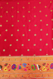 Paithani pure silk saree in peacock green  with floral motifs all over the body.