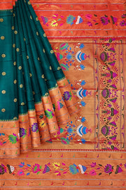Paithani pure silk saree in peacock green  with floral motifs all over the body.