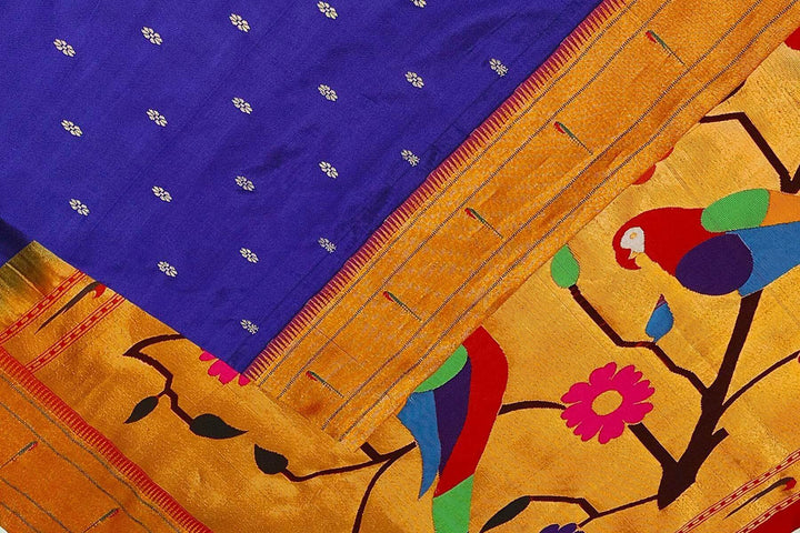 Paithani pure silk saree in royal blue with small floral motifs  on the body .