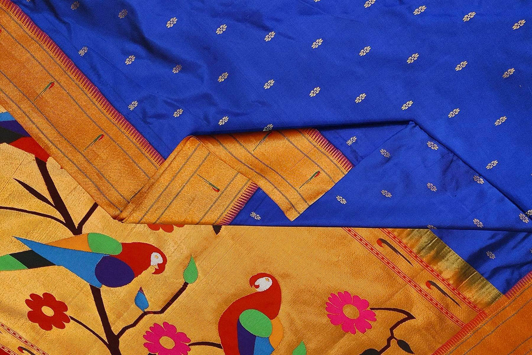 Paithani pure silk saree in royal blue with small floral motifs  on the body .