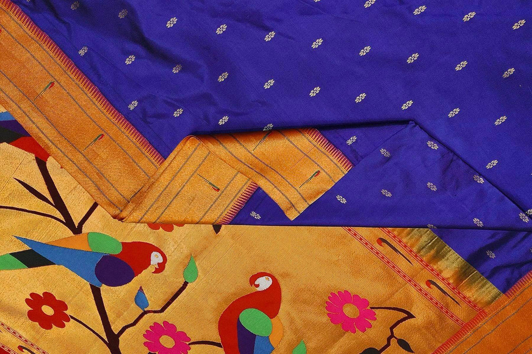 Paithani pure silk saree in royal blue with small floral motifs  on the body .