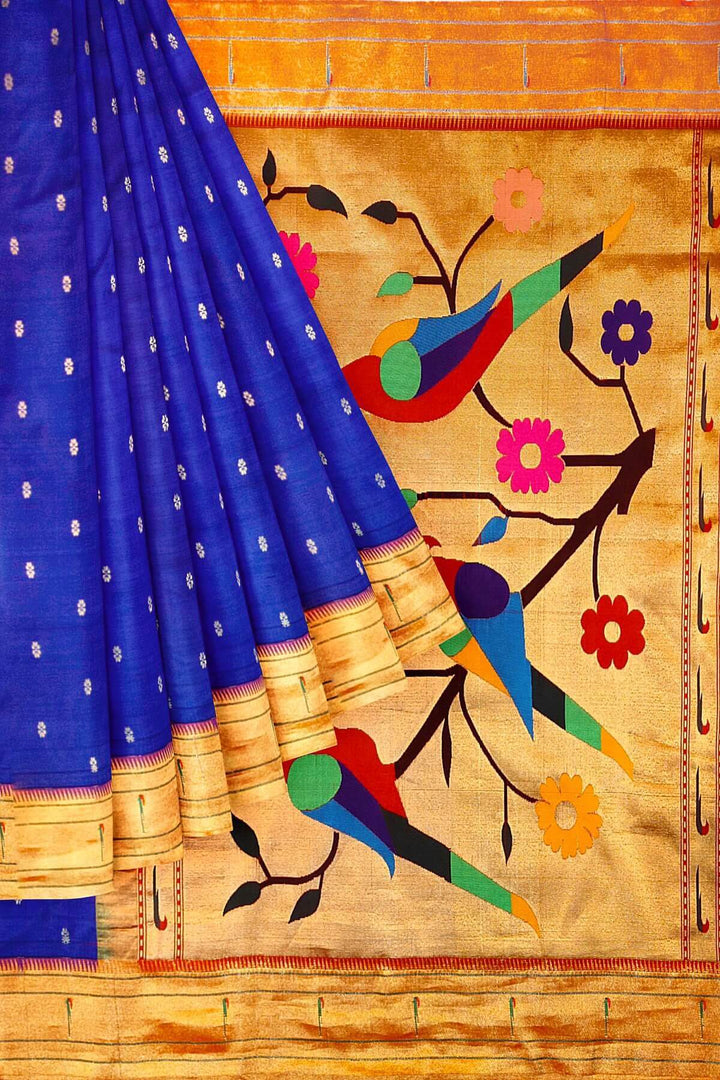 Paithani pure silk saree in royal blue with small floral motifs  on the body .