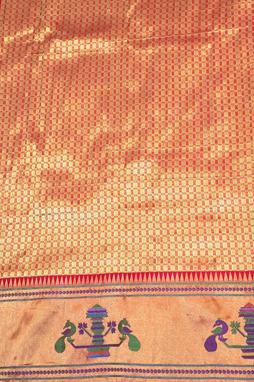 Paithani pure silk saree in purple with floral motifs on the body.