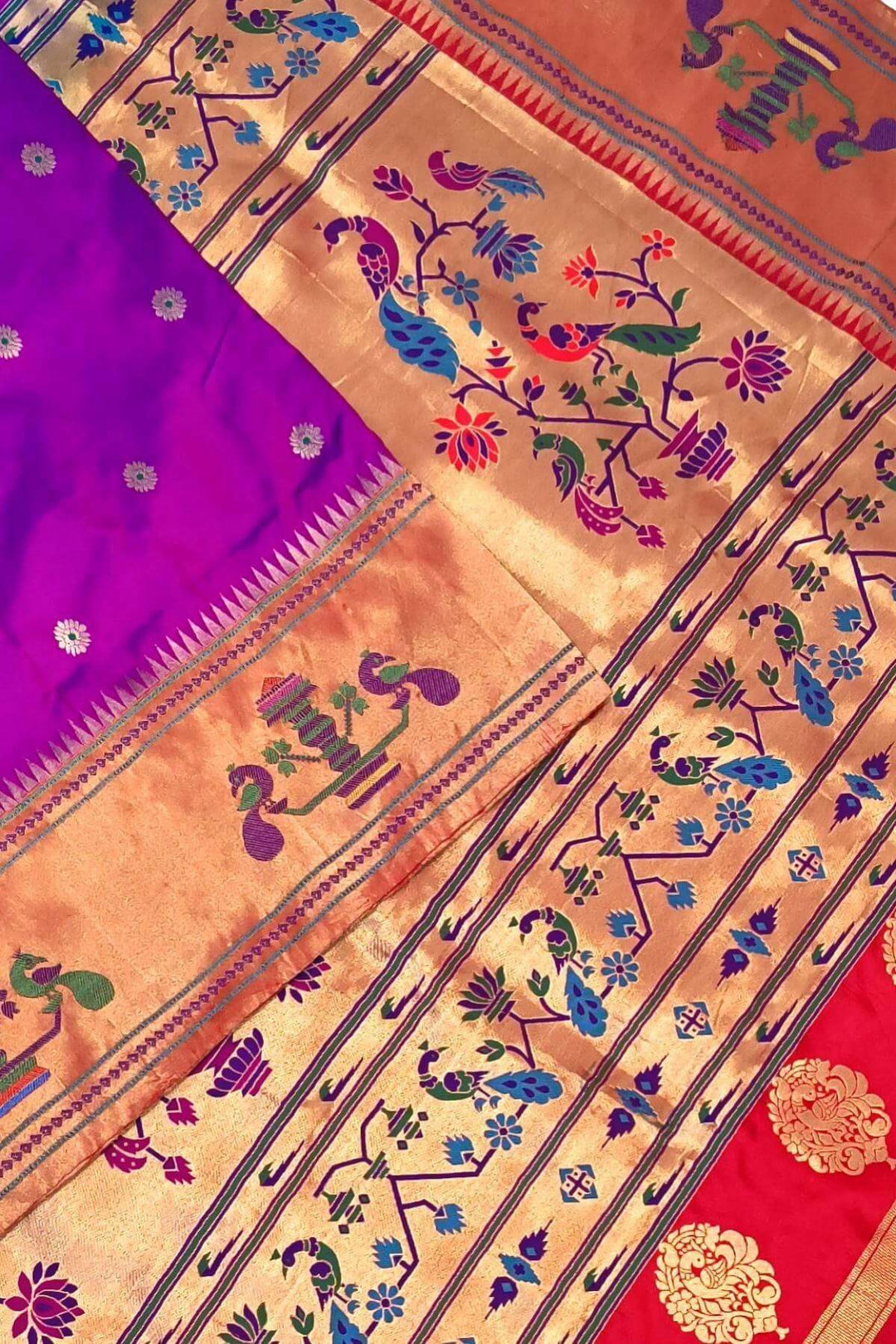 Paithani pure silk saree in purple with floral motifs on the body.