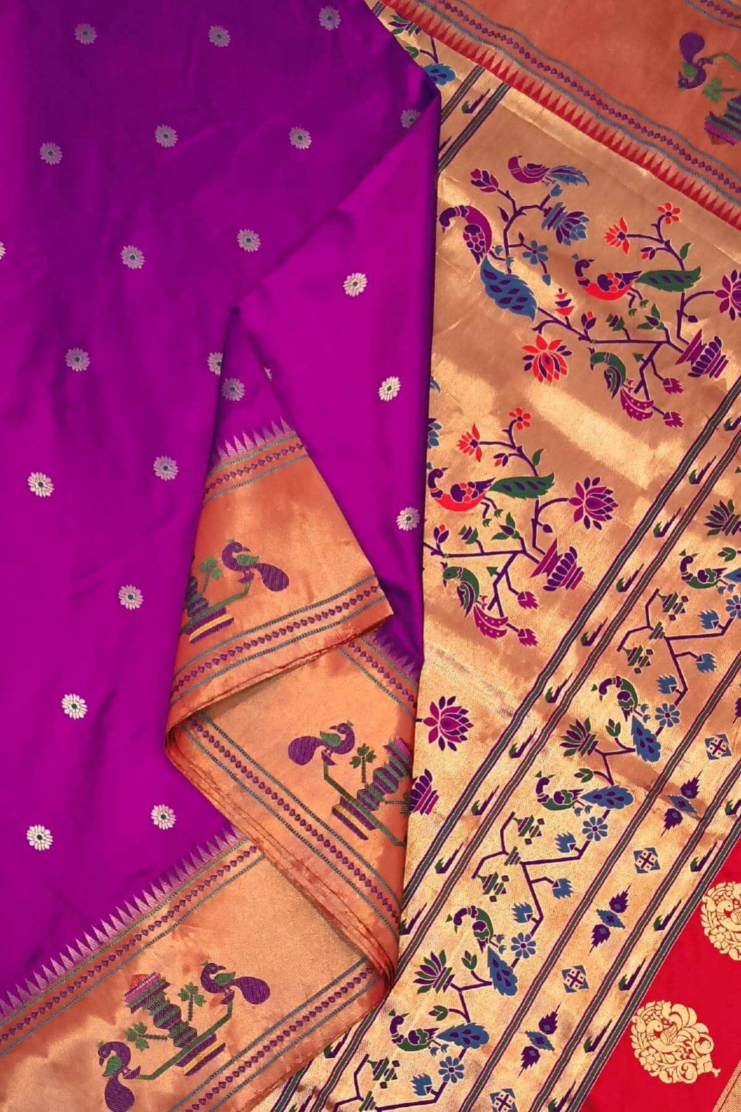 Paithani pure silk saree in purple with floral motifs on the body.