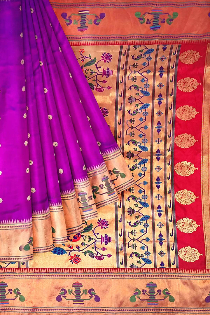 Paithani pure silk saree in purple with floral motifs on the body.