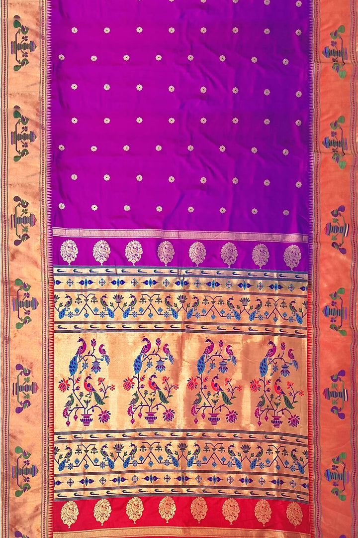 Paithani pure silk saree in purple with floral motifs on the body.