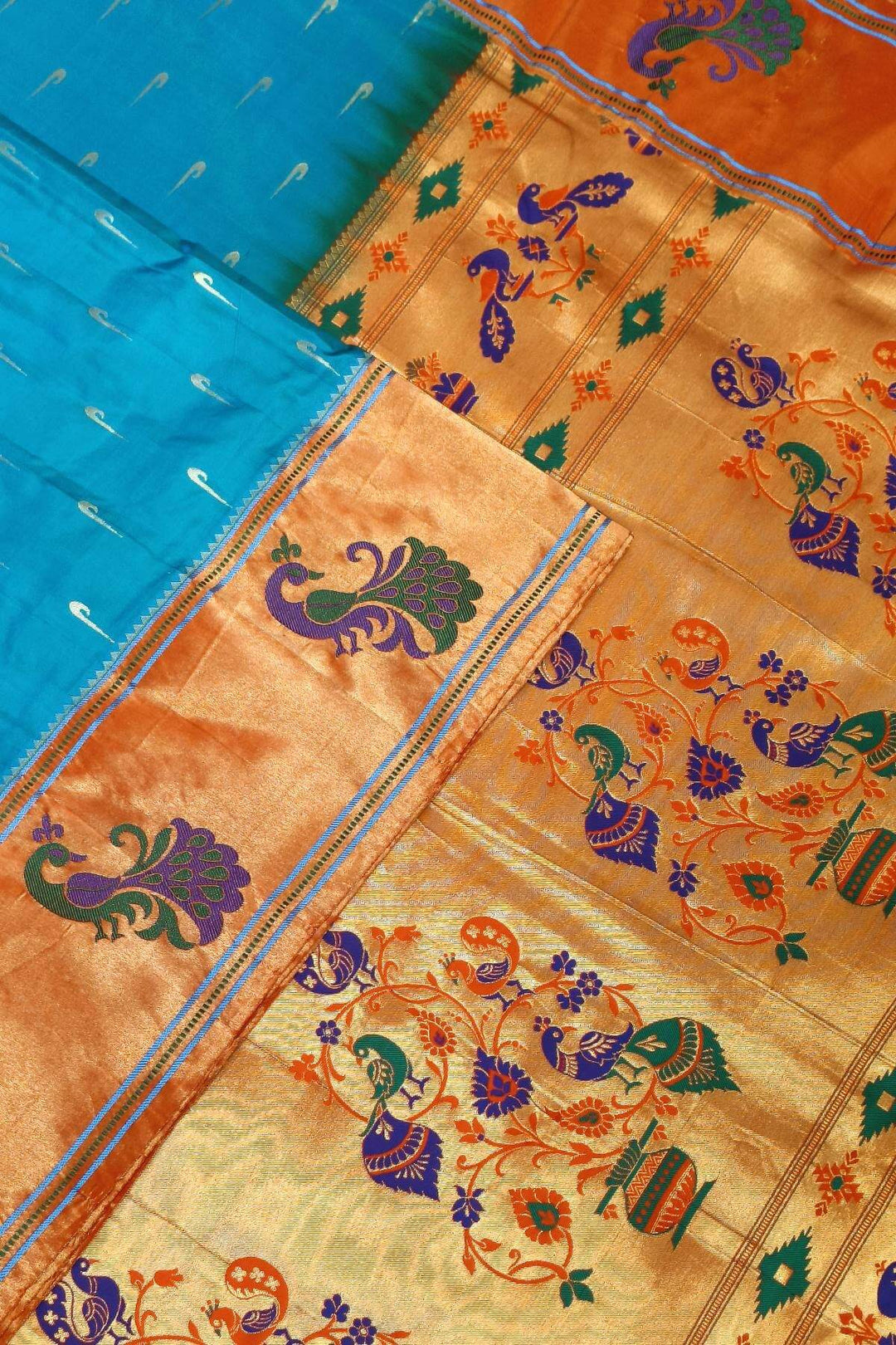 Paithani pure silk saree in blue with muniya motifs on the body.