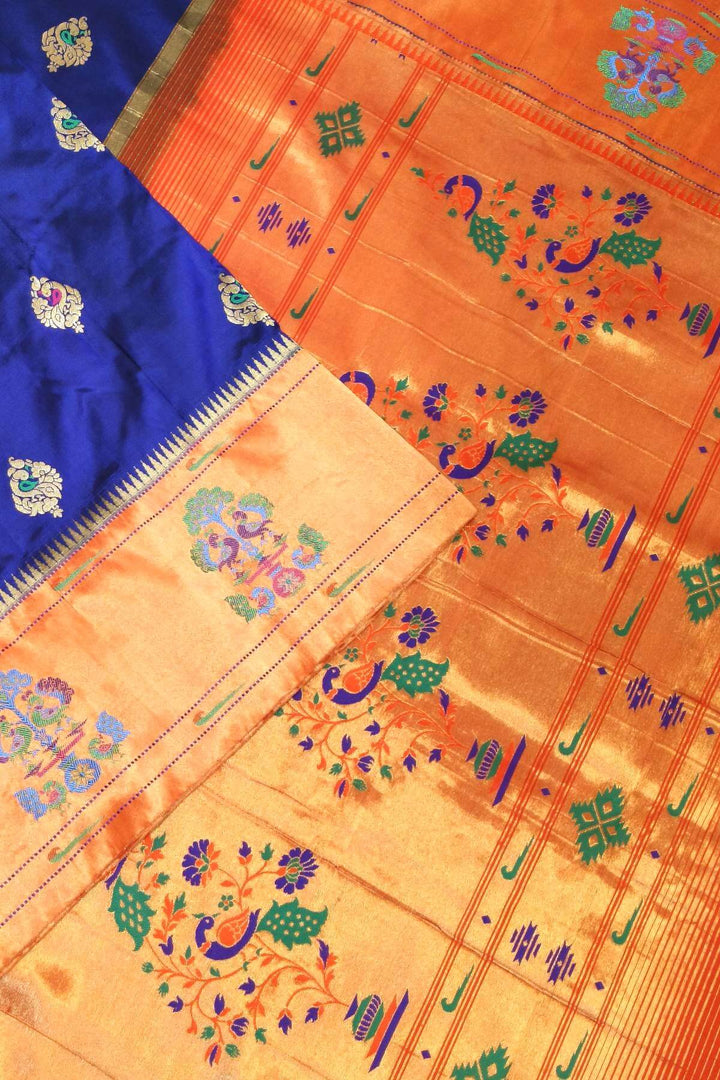 Paithani pure silk saree in violet with peacock motifs on the body.