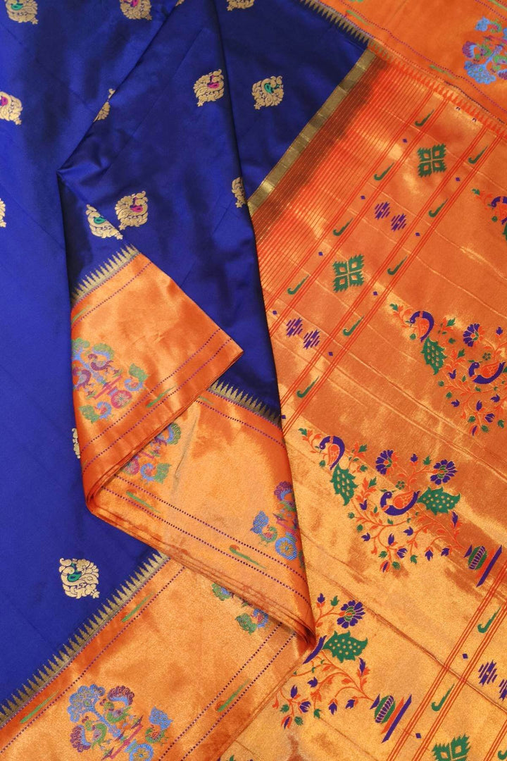 Paithani pure silk saree in violet with peacock motifs on the body.