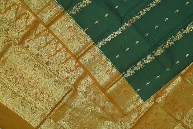 Kora silk saree in green with  floral motifs in gold