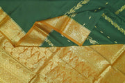 Kora silk saree in green with  floral motifs in gold