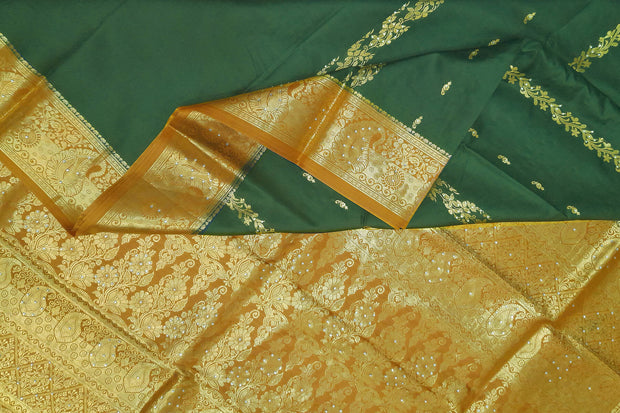 Kora silk saree in green with  floral motifs in gold