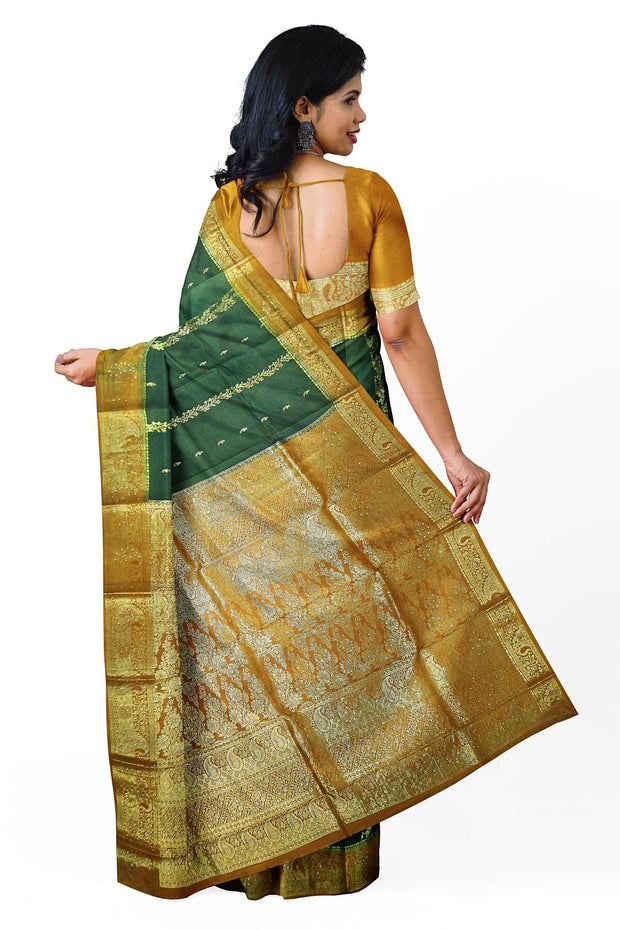 Kora silk saree in green with  floral motifs in gold