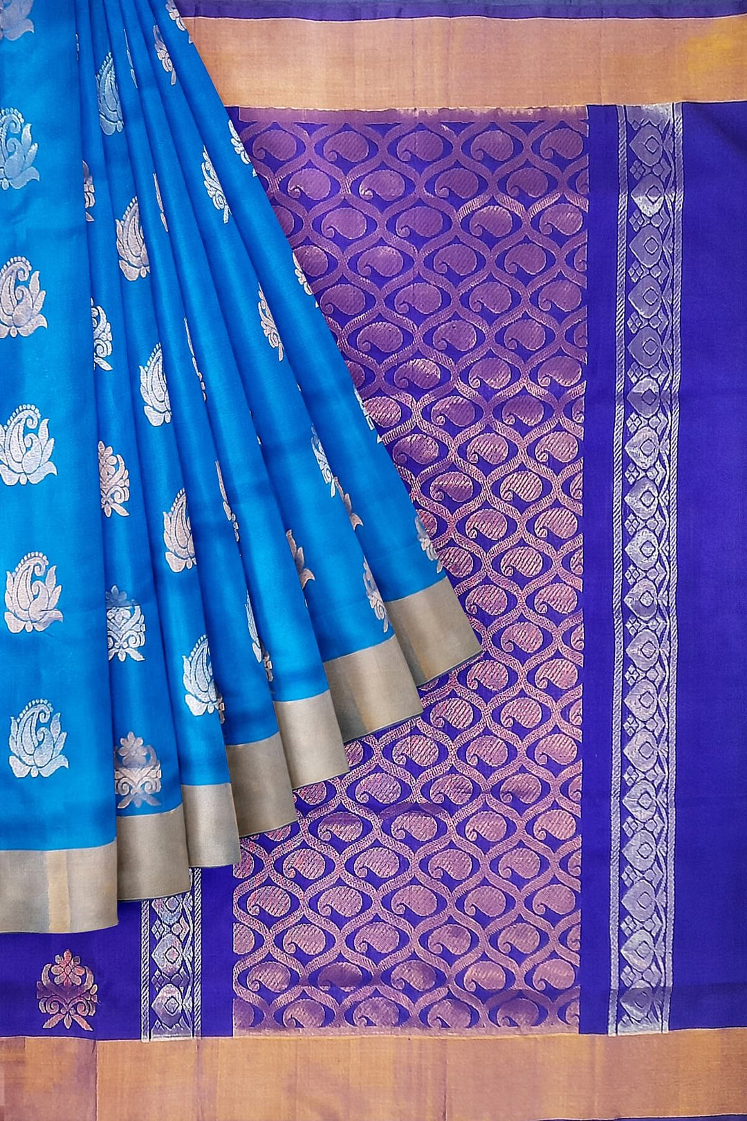 Handwoven Uppada pure silk saree in torquoise blue with floral motifs in gold & silver.