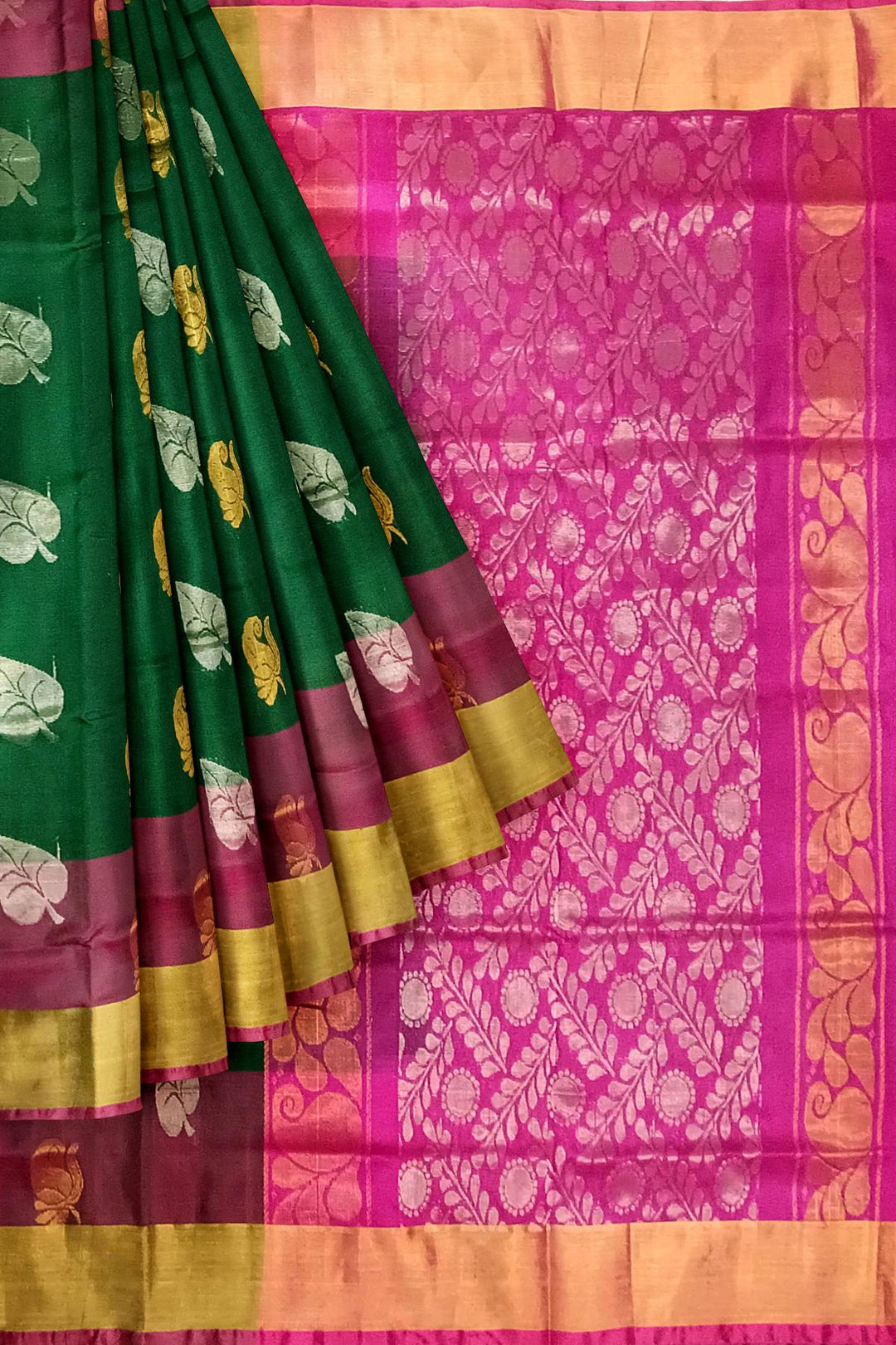 Handwoven Uppada pure silk saree in bottle  green with gold & silver motifs .