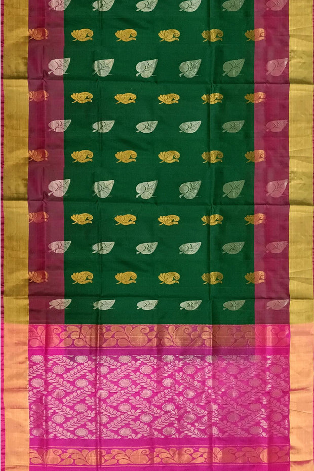Handwoven Uppada pure silk saree in bottle  green with gold & silver motifs .