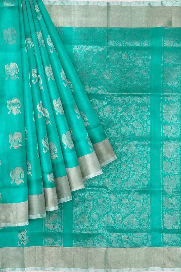 Handwoven Uppada pure silk saree in teal green with  floral motifs .