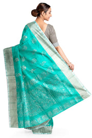 Handwoven Uppada pure silk saree in teal green with  floral motifs .