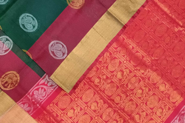 Handwoven Uppada pure silk saree in bottle green with gold & silver motifs .