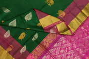 Handwoven Uppada pure silk saree in bottle  green with gold & silver motifs .