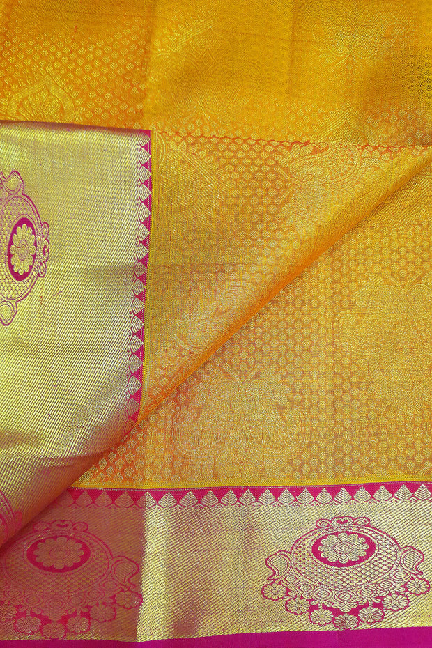 Kanchi silk brocade saree in yellow with contrast pallu in pink