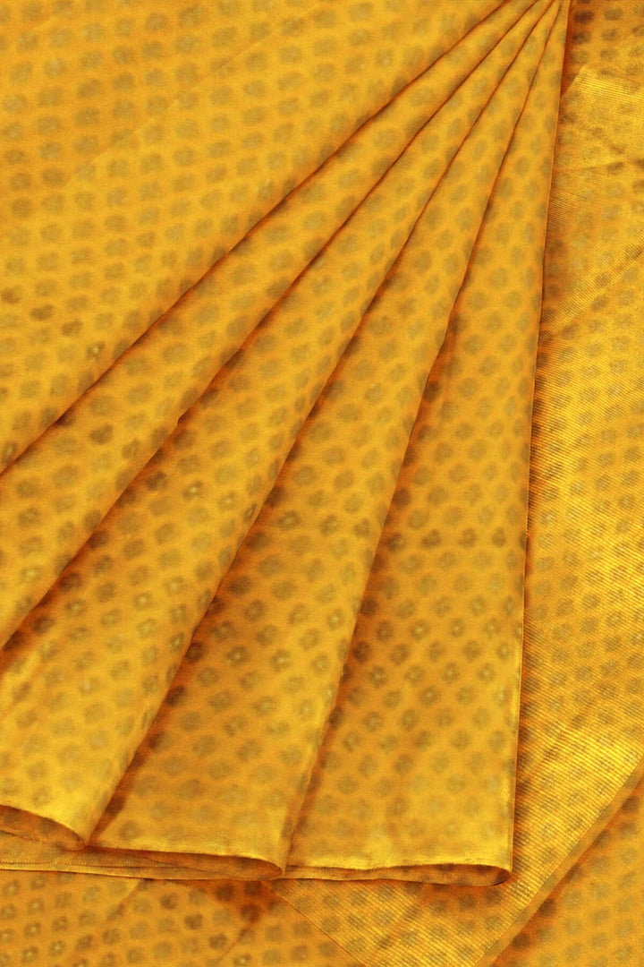 Banarasi  silk fabric in saffron yellow . Available in multiples of 1M & 2.5M