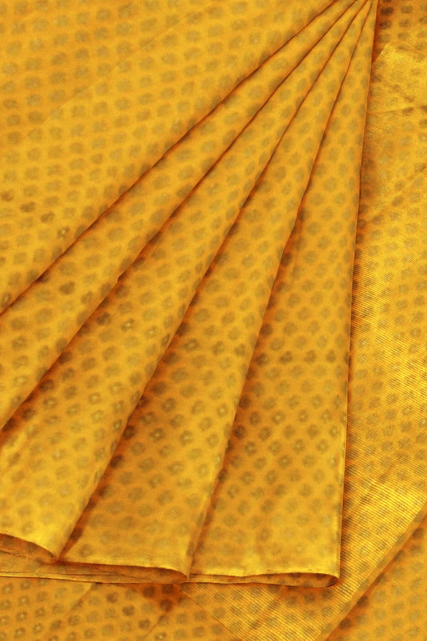Banarasi  silk fabric in saffron yellow . Available in multiples of 1M & 2.5M