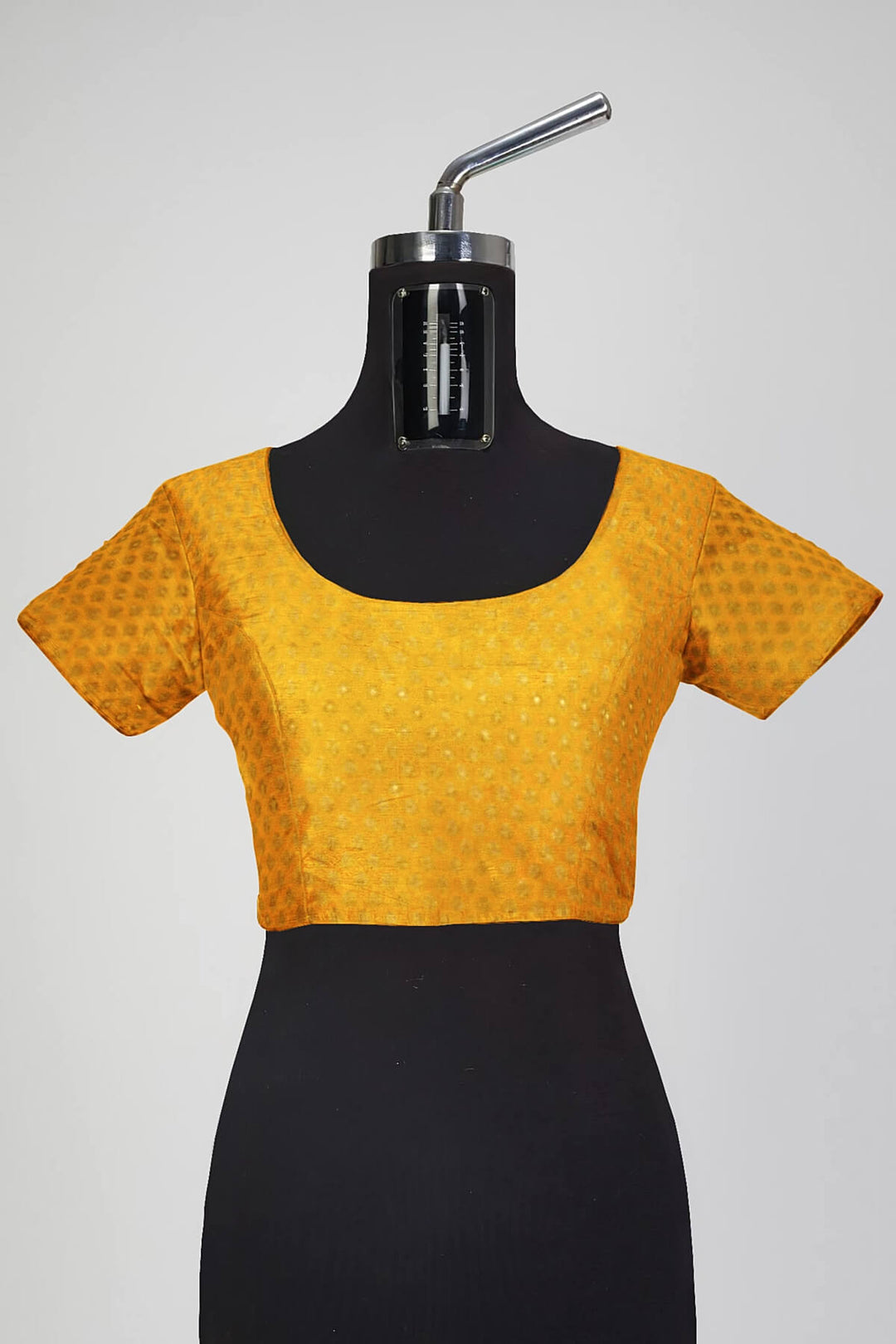 Banarasi  silk fabric in saffron yellow . Available in multiples of 1M & 2.5M