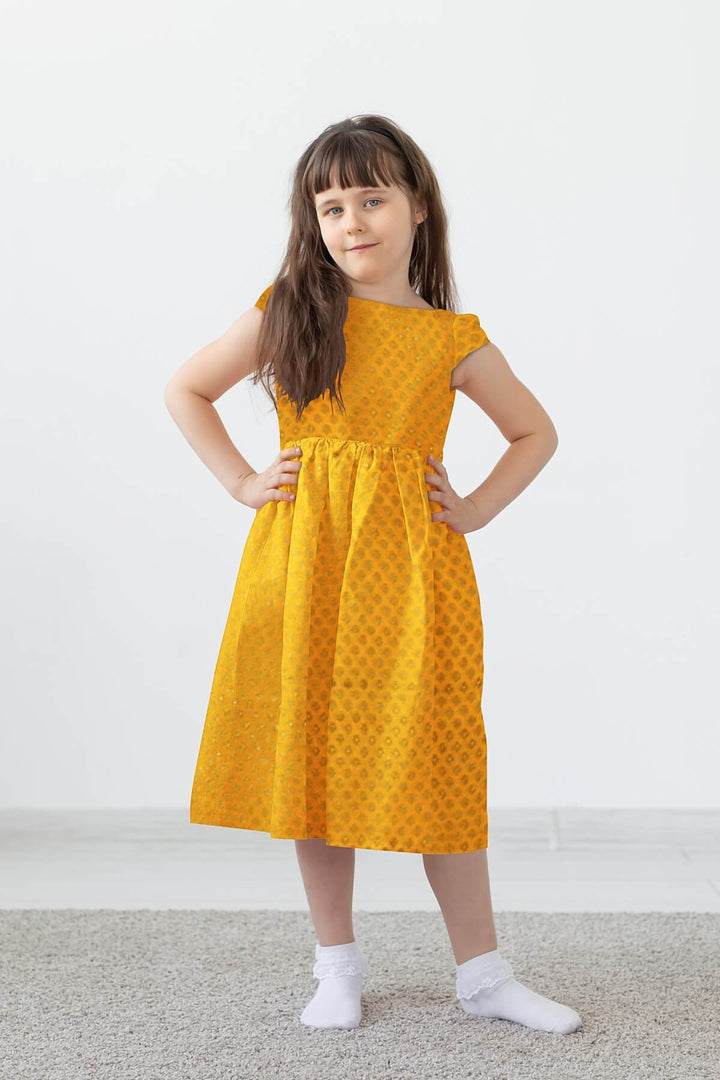 Banarasi  silk fabric in saffron yellow . Available in multiples of 1M & 2.5M