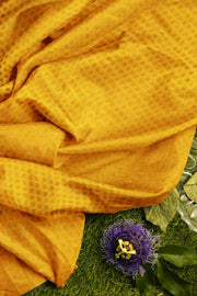 Banarasi  silk fabric in saffron yellow . Available in multiples of 1M & 2.5M