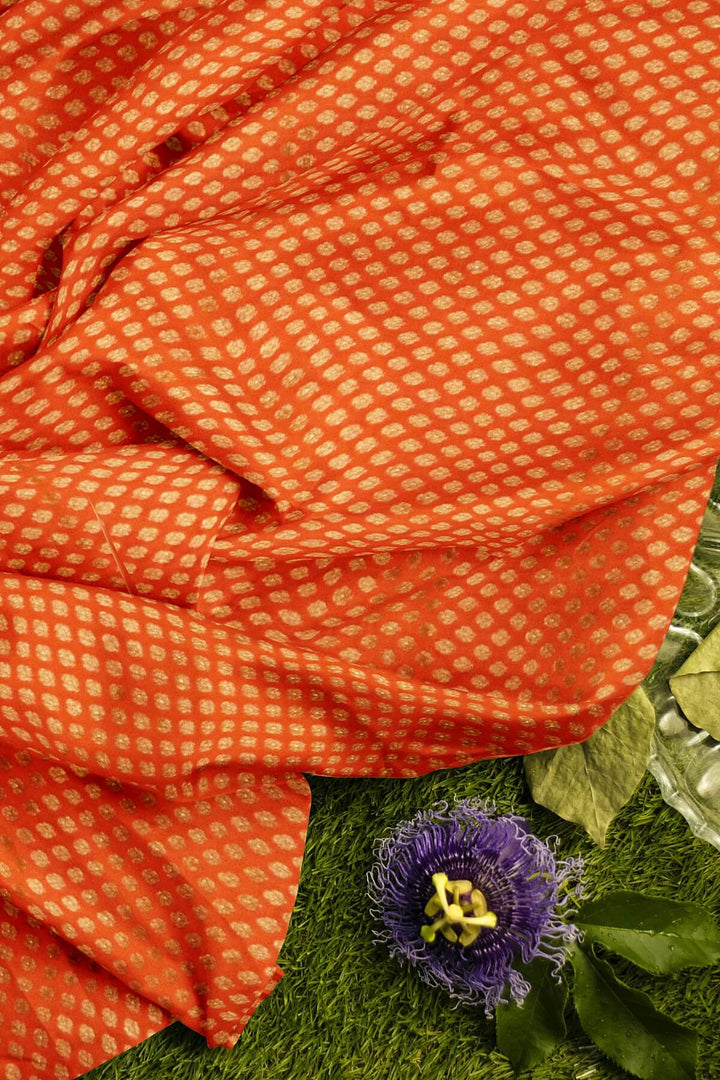 Banarasi  silk fabric in orange. Available in multiples of 1M & 2.5M
