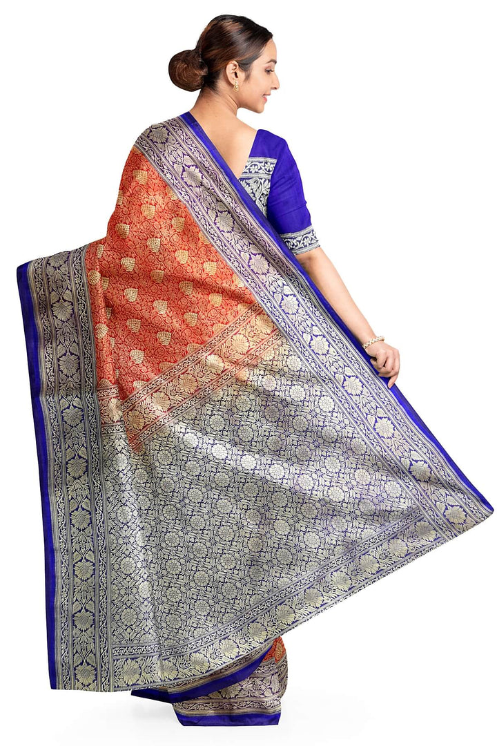 Handloom Banarasi silk saree in satin weave in red with floral motifs all over the body.