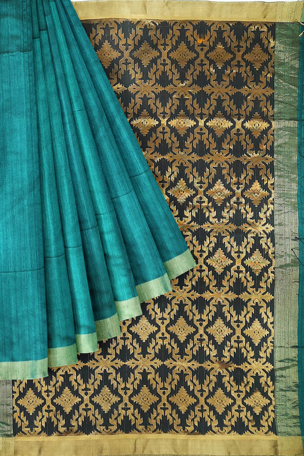 Matka silk saree in teal blue with a  jamdani weave pallu in geometric pattern
