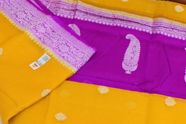 Banarasi silk chiffon  saree in mustard  with silver buttis & border and a contrast pallu in purple