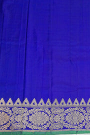 Handwoven Gadwal pure silk saree in purple with floral motifs all over the body.